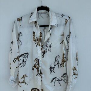 White, long-sleeved, button-down shirt featuring a horse print pattern